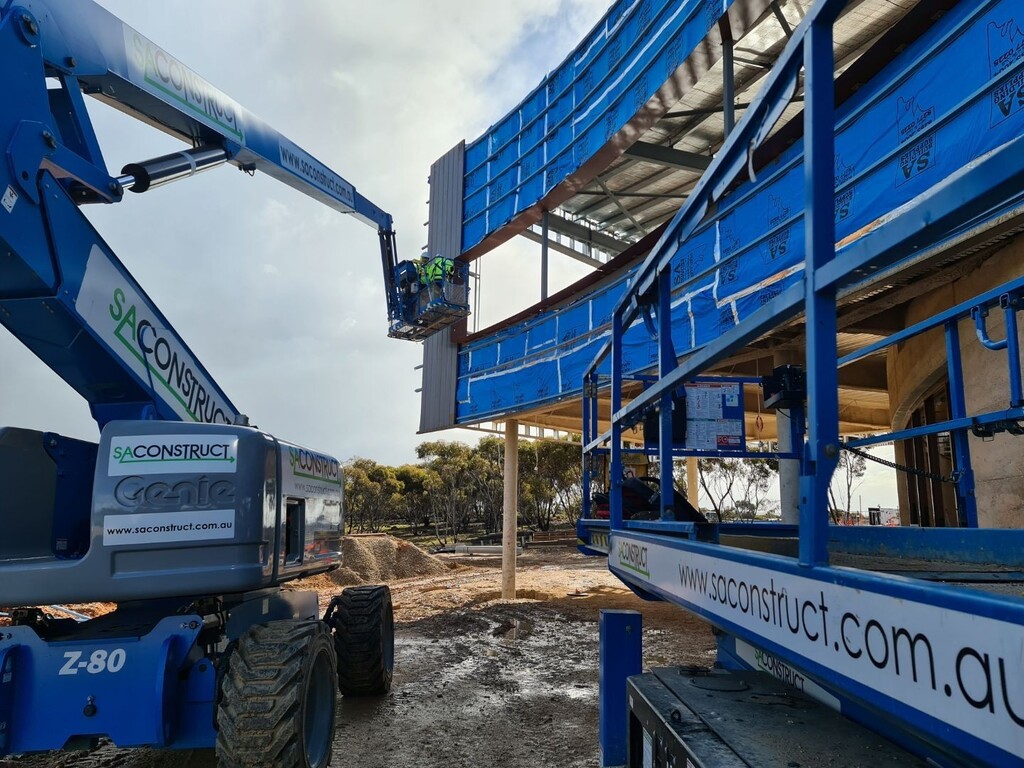 SA Construct branded boom lift and scissor lift on a building site